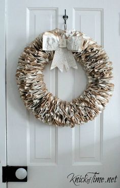 an image of a wreath made out of books on the front door with a bow