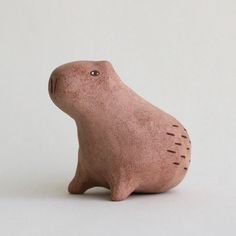 a small clay animal sitting on top of a table