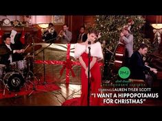 a group of people that are standing in front of a christmas tree with musical instruments