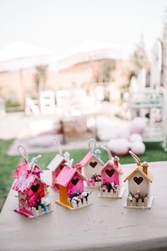 small birdhouses with hearts on them sitting on a table