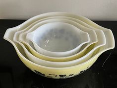 three yellow and white bowls stacked on top of each other