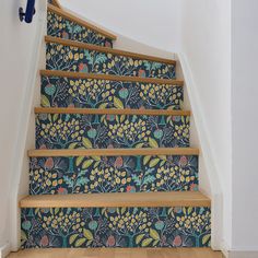 the stairs are decorated with floral wallpaper