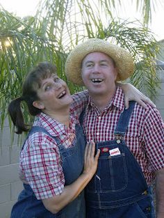 a man and woman in overalls hugging each other