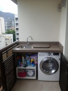 a washer and dryer in a small room with an open shelf above the sink