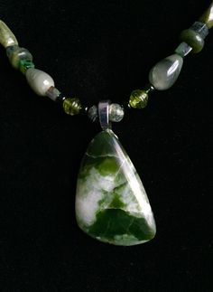 "Moss Agate is a chalcedony with green inclusions and has some translucence. This necklace features Moss Agate beads (square), Green Zebra Jasper beads, Jade beads and silver spacer beads as well as a variety of complimentary beads. The pendant  Measures 25mm X 36mm X 5mm thick. Length of necklace overall is 18 1/2\".  A base metal bail is attached with e6000 industrial strength glue and a base metal toggle is used for closure.  Moss Agate is known as the 'Stone of Friendship'." Green Zebra, Zebra Jasper, Stone Beaded Necklace, Beaded Pendant Necklace, Pretty Jewelry, Jasper Beads, Jade Beads, Natural Shapes, Agate Beads