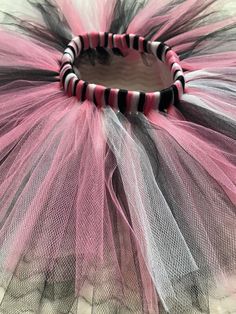 a close up of a pink and black tulle