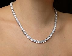 "Brand new sterling silver tennis necklace featuring brilliant round cut created diamond simulants totaling 55.00-99.00tcw. This exquisite necklace has high polished rhodium finish that gives it a stunning shiny look that lasts for many years. Our created diamonds are synthetic simulants that feature brighter D color , FL / VVS1 clarity and ideal cut making them visually indistinguishable from natural diamonds that cost thousands of dollars. We only use high quality solid gold/silver in our jewe Diamond Tennis Necklace, Nugget Necklace, Bow Necklace, Wrap Necklaces, Diamond Simulant, Pretty Necklaces, Tennis Necklace, Diamond Fashion, Sterling Silver Necklaces