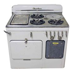 an old white stove with four burners and two oven doors on the front side