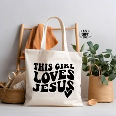 "This Girl Love Jesus Tote, Easter Gifts, Christian Tote Bag, Religious Saying Tote Bag, Bible Verse Tote Bag, Trendy Totes, Canvas Tote Bags Personalized tote bags are perfect for yourself, Your Company, or as a gift! These are also the ideal bride's, Bridal Shower, Baby Shower, Birthday Party, gift, or proposal gift. IMPORTANT! Natural, White, Gold, Yellow, And Pink color totes Will be black Text color; all Other Colors Will Be White. PRODUCT *Measurements15\"L x 16\"H *12 oz./yd² (US), 20 oz (CA), 100% heavy cotton canvas *20\" canvas webbed handles * 9\" handle drop *Made from Heavy duty cotton canvas fabric *DTF printing for the best color quality * Bulk discounts are available upon request. *Put N/A In the personalization Box For  Blank Tote Bag  Check the Tote bag Color And Text Col Jesus Tote Bag, Blank Tote Bag, Beautiful Tshirts, Small Business Design, Christian Tote Bags, Black Jesus, Group Crafts, Christian Crafts, Personalized Tote Bags