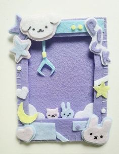 this is an image of a purple felt frame with animals and stars on the edges