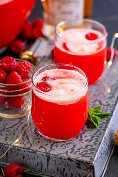 two glasses filled with raspberry punch on a table