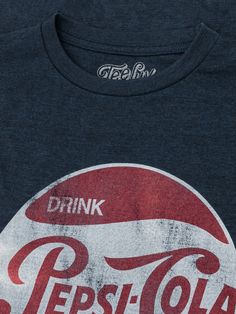 Vintage Never Looked So Good There's nothing like a classic Pepsi Cola! Inspired by the refreshing and absolutely timeless taste - our team created a classic tee just for Pepsi fans. We selected the retro "Drink Pepsi Cola" logo and gave it a fun, distressed look. To complete the vintage feel on this Pepsi shirt, we've printed it on the highest quality poly-cotton navy heather tee we could find. Poly/Cotton Soft Touch Tee Machine Wash Tumble Dry Regular Fit Printed in USA Retro Soft-washed T-shirt For Fan Merchandise, Retro Tan Crew Neck Top, Pepsi Shirt, Pepsi Cola, Retro Logo, Logo T Shirt, Vintage 1950s, The Vintage, Tshirt Logo