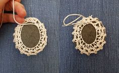 someone is stitching together two pieces of fabric to make small doily pendants