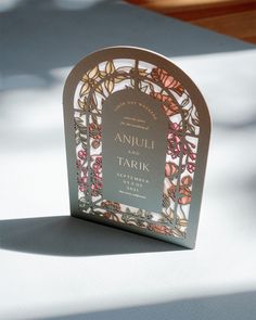 an image of a book with flowers on it sitting on a table in the sun