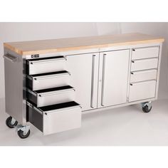 a kitchen island with drawers and wheels on it