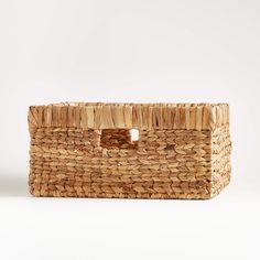 a woven basket with a hole in the middle on a white background, it is empty