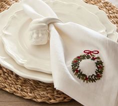 a white plate with a christmas wreath on it and a napkin tied around the edge