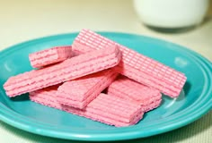 some pink waffles are on a blue plate