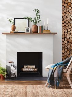 a living room with a fire place next to a wall covered in logs and plants