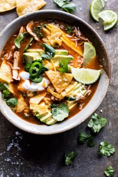 a bowl filled with tortilla soup and garnished with cilantro