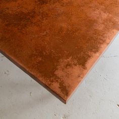 a brown table top sitting on top of a white floor