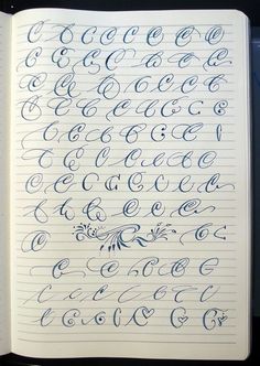 an open notebook with cursive writing on the pages and numbers in blue ink