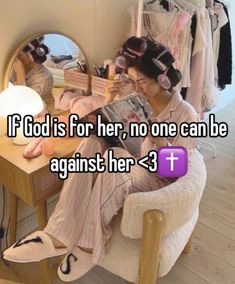 a woman sitting in front of a mirror reading a magazine with the capt if god is for her, no one can be against her > 3