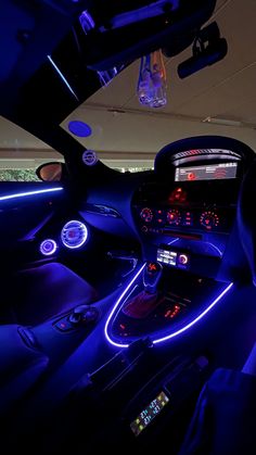 the interior of a car is lit up with blue lights