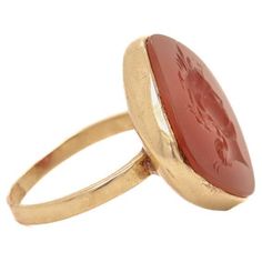 A fine antique intaglio ring. Likely converted from an antique button or pin. In 14k gold With a carved carnelian cabochon depicting an unidentified Roman hero. Marked 14k to the shank. Simply a wonderful intaglio ring! Date: some parts 20th Century, remainder possibly earlier. Overall Condition: It is in overall good, as-pictured, used estate condition. Condition Details: There is some light denting to the bezel setting. Otherwise, there is some light edge wear, some fine and light surface scra Antique Carved Signet Ring, Victorian 14k Gold Intaglio Engraved Ring, Antique Carved Signet Ring For Formal Occasions, Antique Ceremonial Signet Ring With Intaglio, Victorian Yellow Gold Engraved Ring With Intaglio, Ceremonial Oval Signet Ring With Intaglio, Victorian Engraved Yellow Gold Ring With Intaglio, Antique Intaglio Signet Ring For Ceremonial Occasions, Victorian 14k Gold Signet Ring With Intaglio