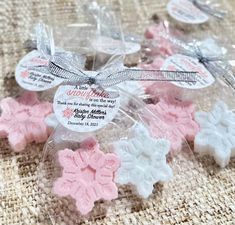 small pink and white snowflakes are packaged in cellophane