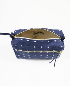 The size of this compact toiletry bag is perfect for your daily essentials and favorite products. The flexible organic-cotton canvas, with a hand-embroidered cross-stitch, is designed to easily fit into any overnight bag, purse, or tote. Also available in a larger size and smaller size. Rectangular Cotton Cosmetic Bag For Daily Use, Everyday Cotton Rectangular Pouch, Cotton Cosmetic Pouch For Everyday Use, Rectangular Cotton Travel Cosmetic Bag, Embroidered Rectangular Cosmetic Bag For Everyday, Rectangular Canvas Cosmetic Bag For Travel, Everyday Rectangular Canvas Cosmetic Bag, Rectangular Canvas Cosmetic Bag For Daily Use, Packing For A Trip