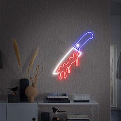 a neon sign with a knife sticking out of it's side on a wall