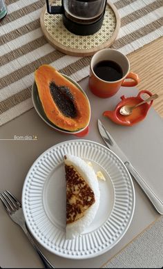 a slice of pie on a plate next to a cup of coffee and spoons