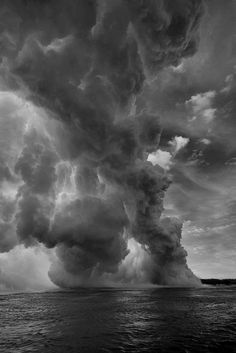 a black and white photo of a large cloud in the sky