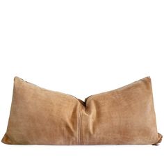 a large brown pillow sitting on top of a white wall