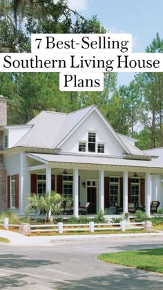 a large white house with red shutters on the front and side windows, surrounded by trees