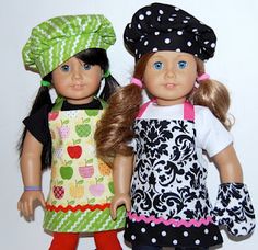 two dolls are standing next to each other