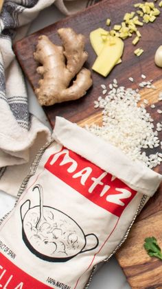 a bag of food sitting on top of a wooden cutting board next to garlic and mushrooms