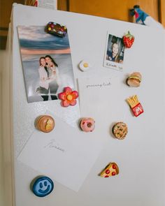 a refrigerator with magnets and pictures on it