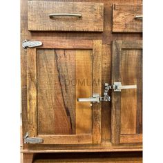 a wooden cabinet with metal handles and drawers