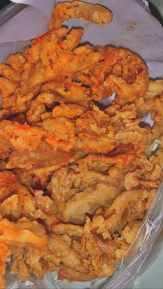 fried food in plastic wrapper sitting on top of a table