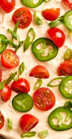 a pizza topped with tomatoes and green peppers