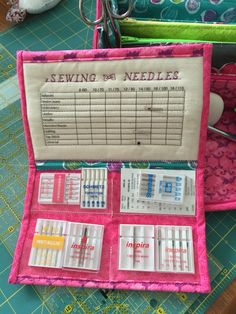 sewing needles are laid out in a pink case