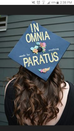 a woman wearing a graduation cap that says in omnia, ready for anything paratus