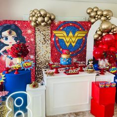 a wonder woman themed birthday party with balloons and decorations