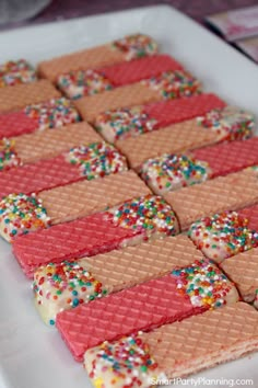 there is a white plate that has some cookies on it with sprinkles