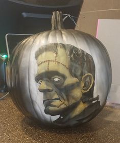 a painted pumpkin with a man's face on it