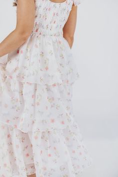 Meet the "It" dress of the season: this midi is our new favorite, forever and always! Crafted from a premium fabric in the most exquisite floral pattern, it features a feminine, flouncy silhouette and ruffle details that will capture your heart - and the spotlight. Whatever special event is next on your calendar - spring weddings, maternity photos, christenings or baby showers - the Forever & Always will set you apart from the crowd in the most elegant of ways. FIT: Runs true to size. Dress will accommodate most baby bumps; note that the bodice is smocked, which could prove restrictive if you are in advanced maternity and carrying high. MATERIAL: Self: 100% Polyester; Lining: 100% Cotton. Hand wash cold; do not bleach, do not tumble dry. Line dry, low iron if needed. GARMENT DETAILS: Light Summer Tea-length Dresses For Brunch, Summer Tea-length Brunch Dress, Feminine Summer Tea-length Dress, Feminine Flowy Maxi Dress For Garden Party, Flowy Midi Dress For Garden Party, Feminine Tea Length Maxi Dress, Spring Tea Length Dress For Brunch, Spring Brunch Tea-length Dress, Feminine Floral Print Dress With Tiered Skirt