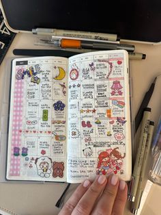 an open notebook with doodles and writing on it