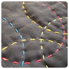 a close up of a piece of cloth with colorful thread sprinkles on it